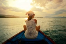 woman-traveling-by-boat-at-sunset-among-the-islands-881x588